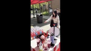 Student playing the pop bottle game at the International Night Market